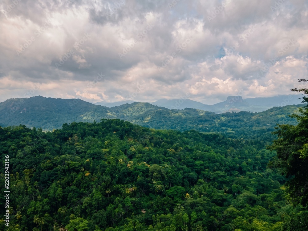 Fototapeta premium Scenic panoramic view of lush green mountains and tropical forests from Kadugannawa viewpoint in Sri Lanka