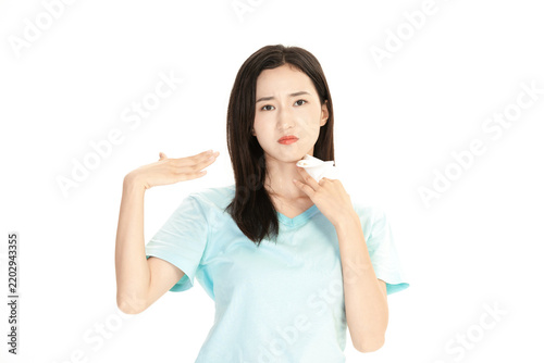 Young woman wiping sweat from neck feeling hot in summer