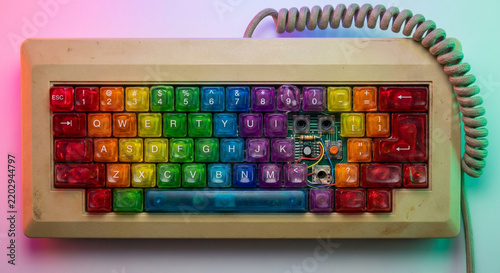 Vintage illuminated keyboard with retro LED keys connected to coiled phone cord