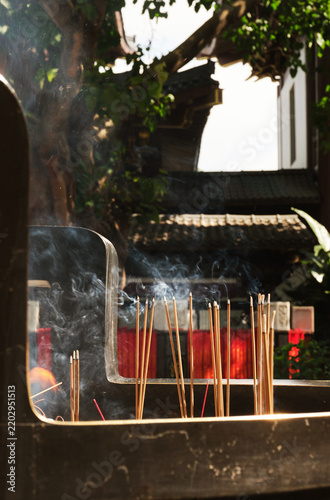 Closeup of burning incense in a large burner at an Eastern temple