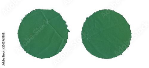 Set of two green circular paper cutouts with torn uneven edges, wrinkled and creased surfaces, handmade round shapes, and visible crumpled texture on transparent background