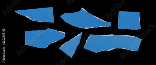Фотография Set of six torn blue paper fragments with irregular angular shapes, rough ripped