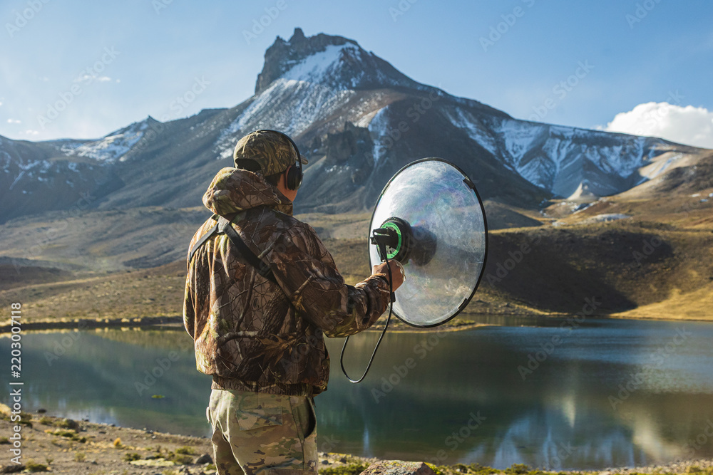Obraz premium Person observing and recording birds in the Peruvian Andes.