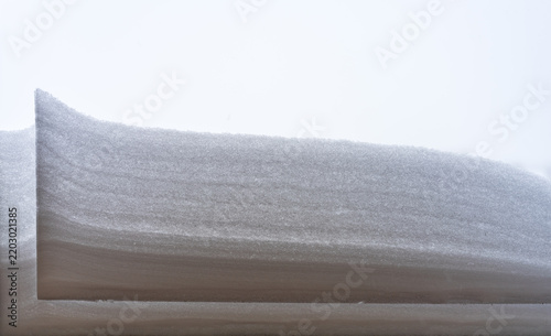 View of a cross-section of a snowbank showing layered accumulation and texture in Vilnius, Vilnius County, Lithuania.