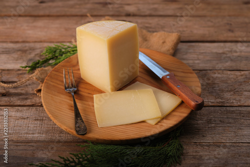 Spanish Aged Cheese With Idiazabal Designation on Wooden Plate