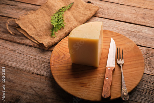Spanish Aged Cheese With Idiazabal Designation on a Wooden Plate