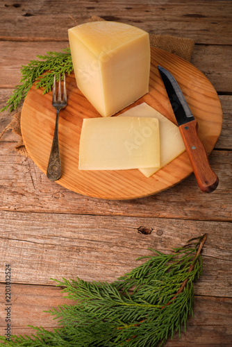 Spanish Aged Cheese With Idiazabal Designation on Wooden Plate