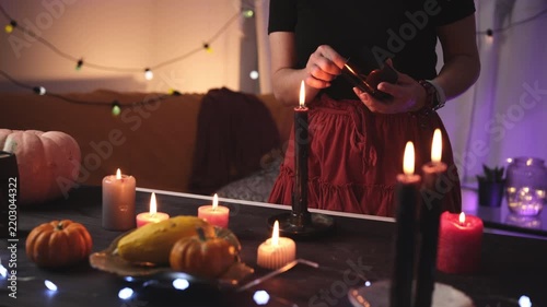 Girl Decorates A Halloween Room By Lighting Candles And Creates A Festive Atmosphere