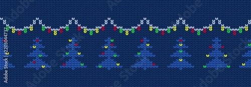 Knitted christmas ornament. Blue christmas tree with lights and garland on navy backround. Seamless border