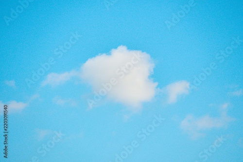 Obraz na plátně Single fluffy white cloud in a bright blue sky