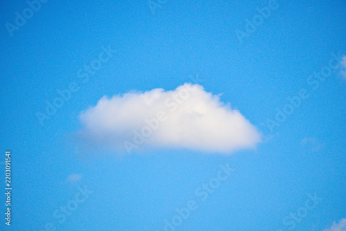 Obraz na plátně Isolated single white fluffy cloud in a clear blue sky
