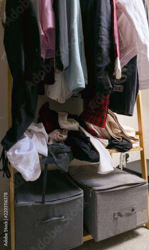 Obraz na płótnie Untidy clothes rack with garments and storage