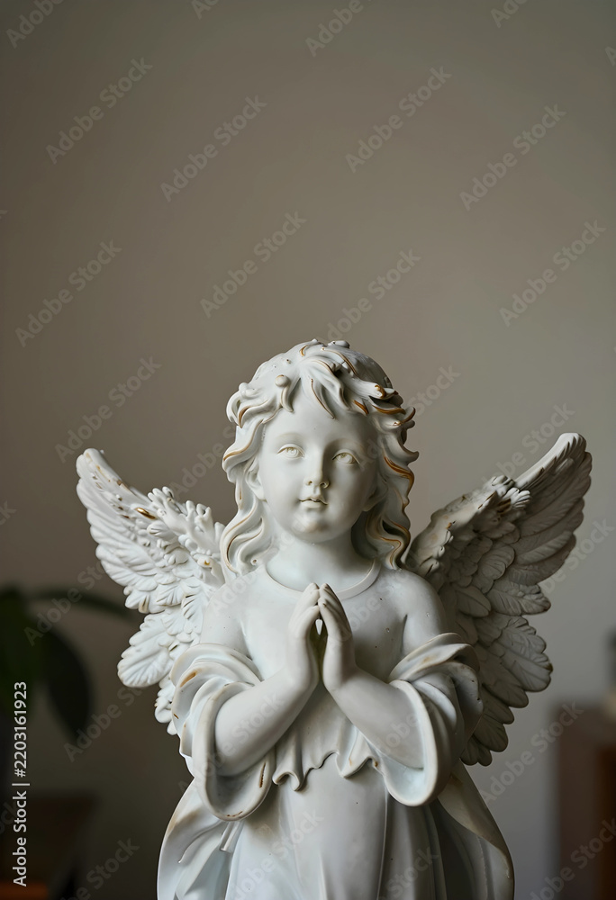 Fototapeta premium Spirituality and faith concept porcelain angel figurine with praying hands for religious peace hope and divine protection in a home interior settings