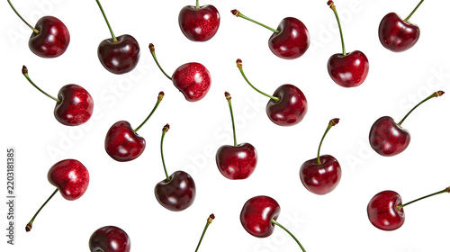 Isolated fresh ripe red cherries with green stems in a scattered random pattern, delicious fruit