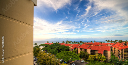 Konstfotografi cinderblock wall with a view over clay tile roofs in front of the Pacific Ocean,