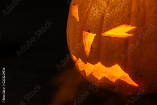 Carved pumpkin with spooky face for Halloween celebration in October