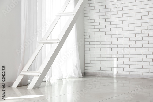 Minimalist interior design and home renovation, white wooden ladder leaning a...