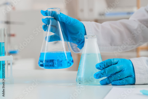 Scientific research and chemical experiment, scientist holding glass flask wi...