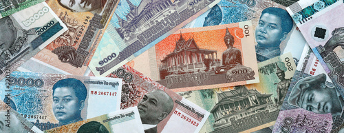Cambodian riel money banknotes pile on table. Cambodia bills of KHR currency close up