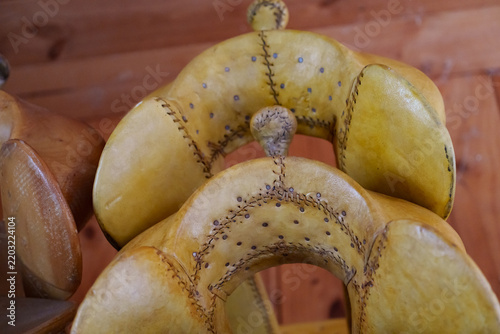 Close-up of rawhide-covered western saddle tree showing stitched details and nail heads