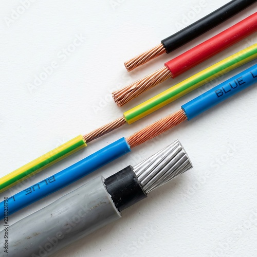 Close-up of various electrical wires and cables on a white background.