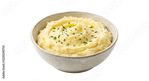 Creamy mashed potatoes in a rustic ceramic bowl garnished with fresh chives and black pepper