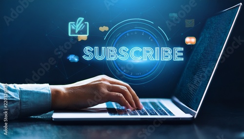 online subscription concept with hand pressing a glowing subscribe button on a laptop dark blue background and confirmation symbol
