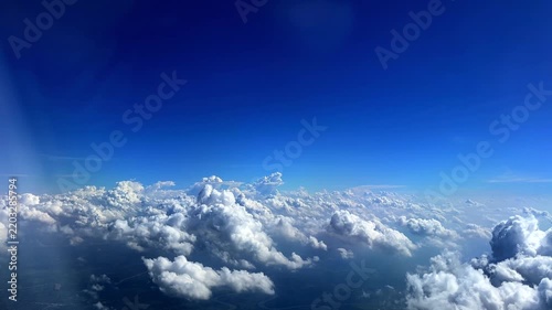 Flying through the clouds aerial view from airplane blue sky