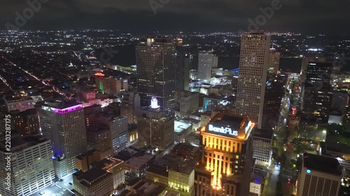 New Orleans, Louisiana at night with downtown modern architecture, illuminated office buildings. City lights emphasize scale of urban skyline.