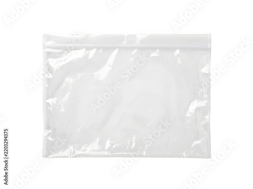 A clear plastic pouch with a sealed edge resting on a plain transparent surface.