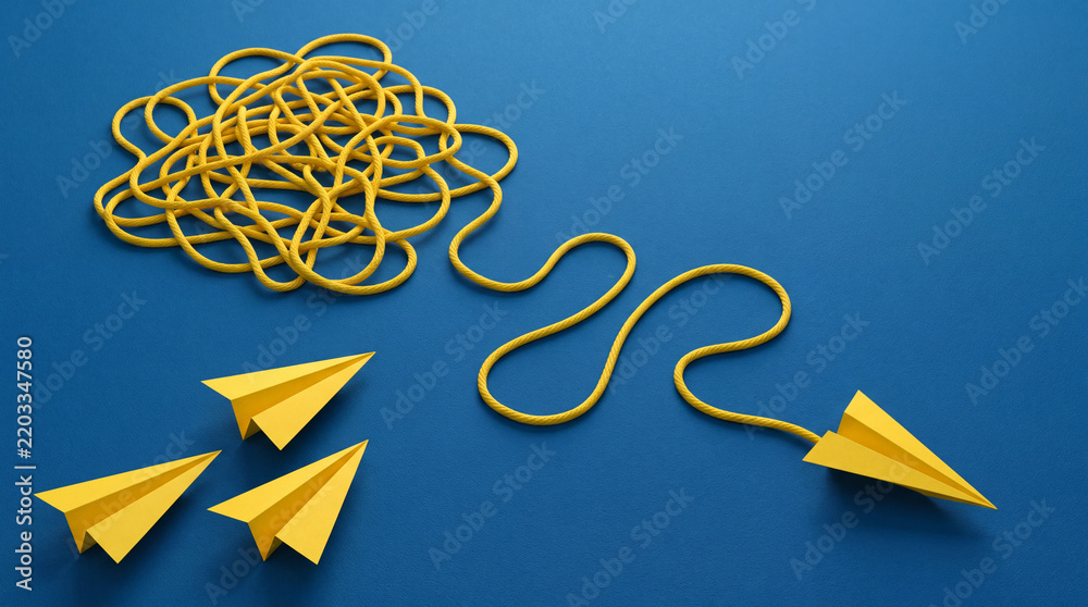 Obraz premium Conceptual image of yellow rope tangled in a knot transitioning into a wavy line connected to a paper airplane on a blue background, symbolizing problem solving, innovation, and simple solutions.