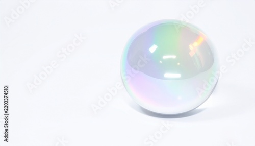 Transparent iridescent glass sphere with colorful rainbow light reflections on a white background