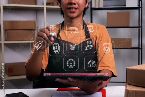 Male Pointing with Stylus Pen at Commercial Sales Interface Icons while Holding Tablet