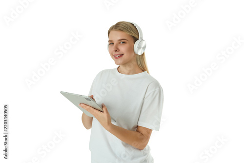 Woman uses tablet and smiles while listening to music. Digital lifestyle concept, PNG
