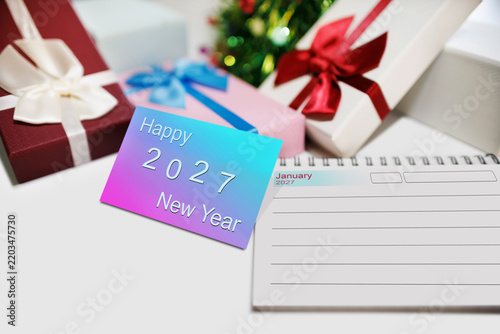 close-up shot, two-tone color of new year card to happy new year 2027 with gift box and christmas background. celebration New Year's Day 2027