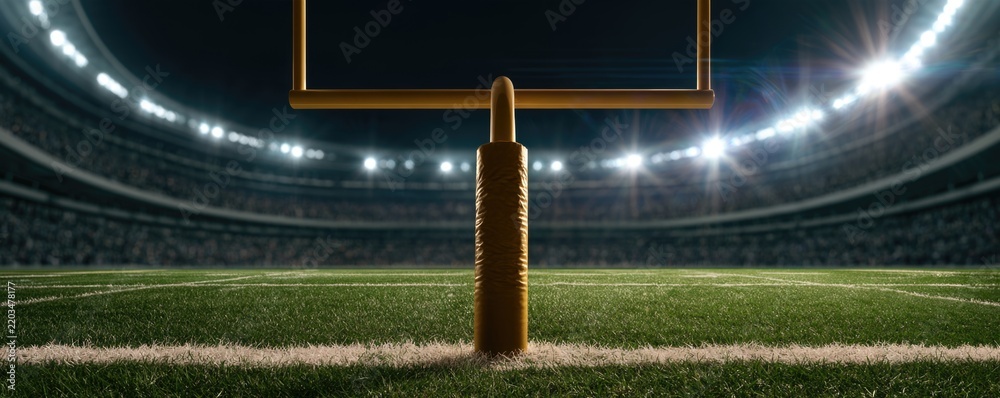 Obraz premium A close-up view of an American football goalpost on a brightly lit stadium field during a night game.