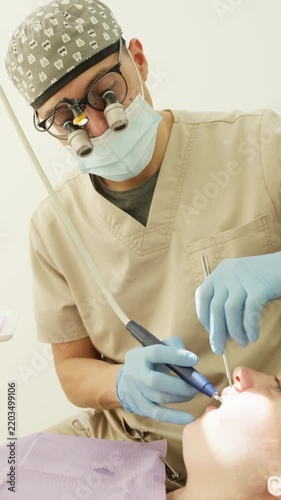 Professional dentist performing oral hygiene procedure