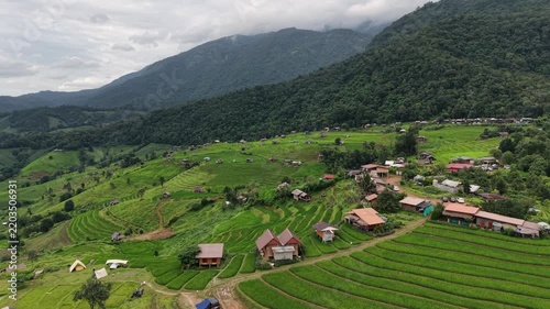 Aerial landscape view of wooden huts in the rice terrace and mountains