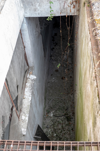 Missing section of metal grating flooring for safe passage over the floor shaft.