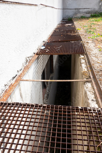 Missing section of metal grating flooring for safe passage over the floor shaft.