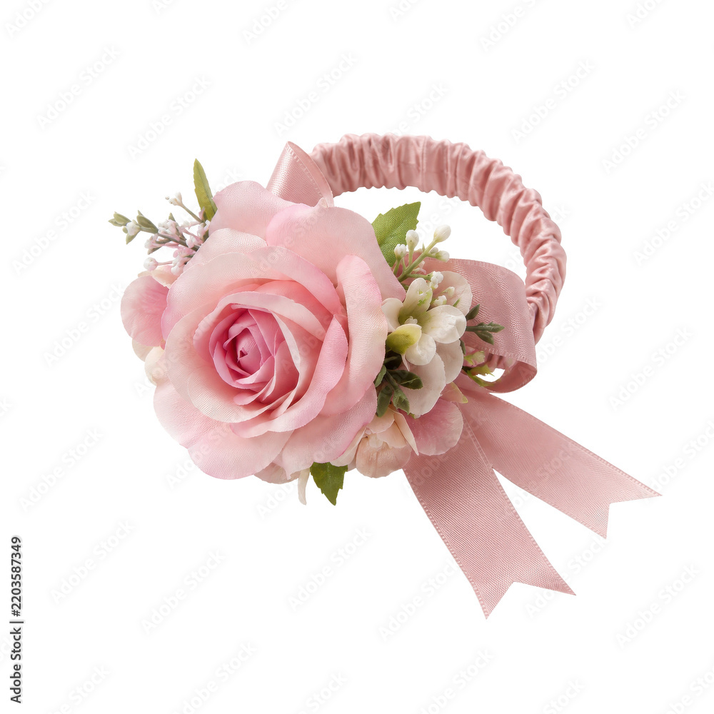 Obraz premium Elegant pink artificial rose corsage with delicate small flowers and a matching ribbon, presented on a clean white background
