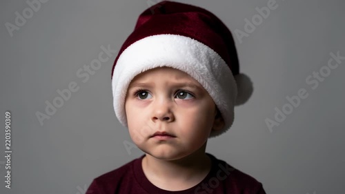 Thoughtful Child in Santa Hat Portrait.