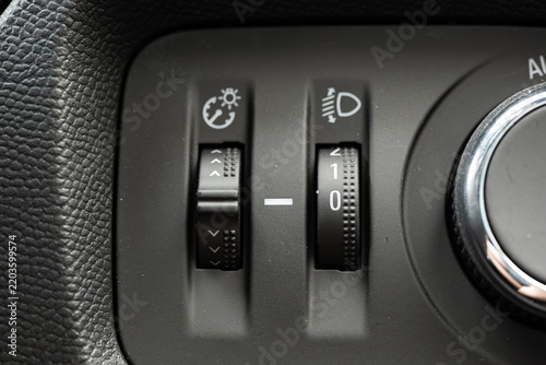 Dashboard illumination brightness dial wheel and headlight height adjustment switch on vehicle control panel