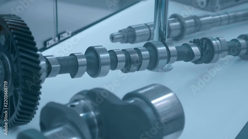 Sample of new crankshaft for truck engine is presented at the exhibition. Closeup. Shot in motion