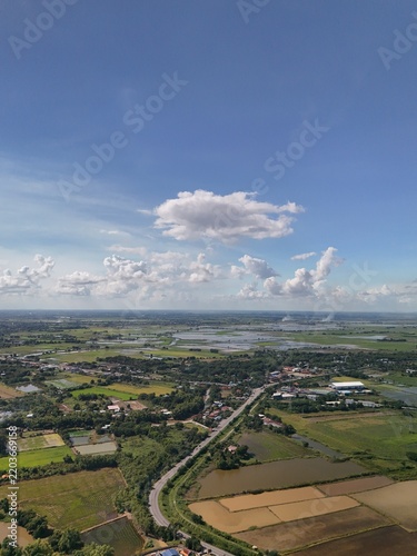 Aerial view of rice field countryside with blue sky and white clouds Agricultural Farmland