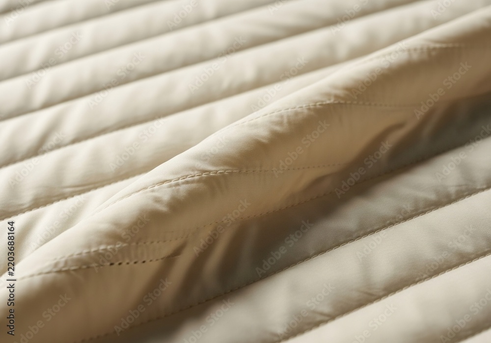 Fototapeta premium Close up of a soft beige quilted fabric texture.