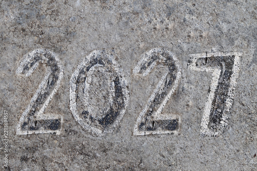 Year 2027 written in paint on concrete
