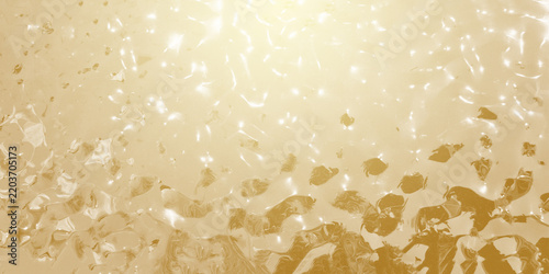 Wide golden metallic textured background with rippling water-like reflections and a bright, shiny surface glow
