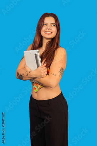 Young woman with laptop smiling looking away