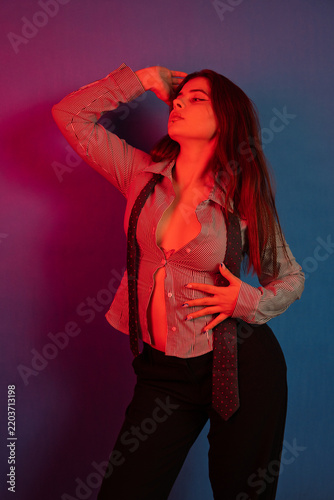 Confident woman posing in stylish pinstripe shirt and tie